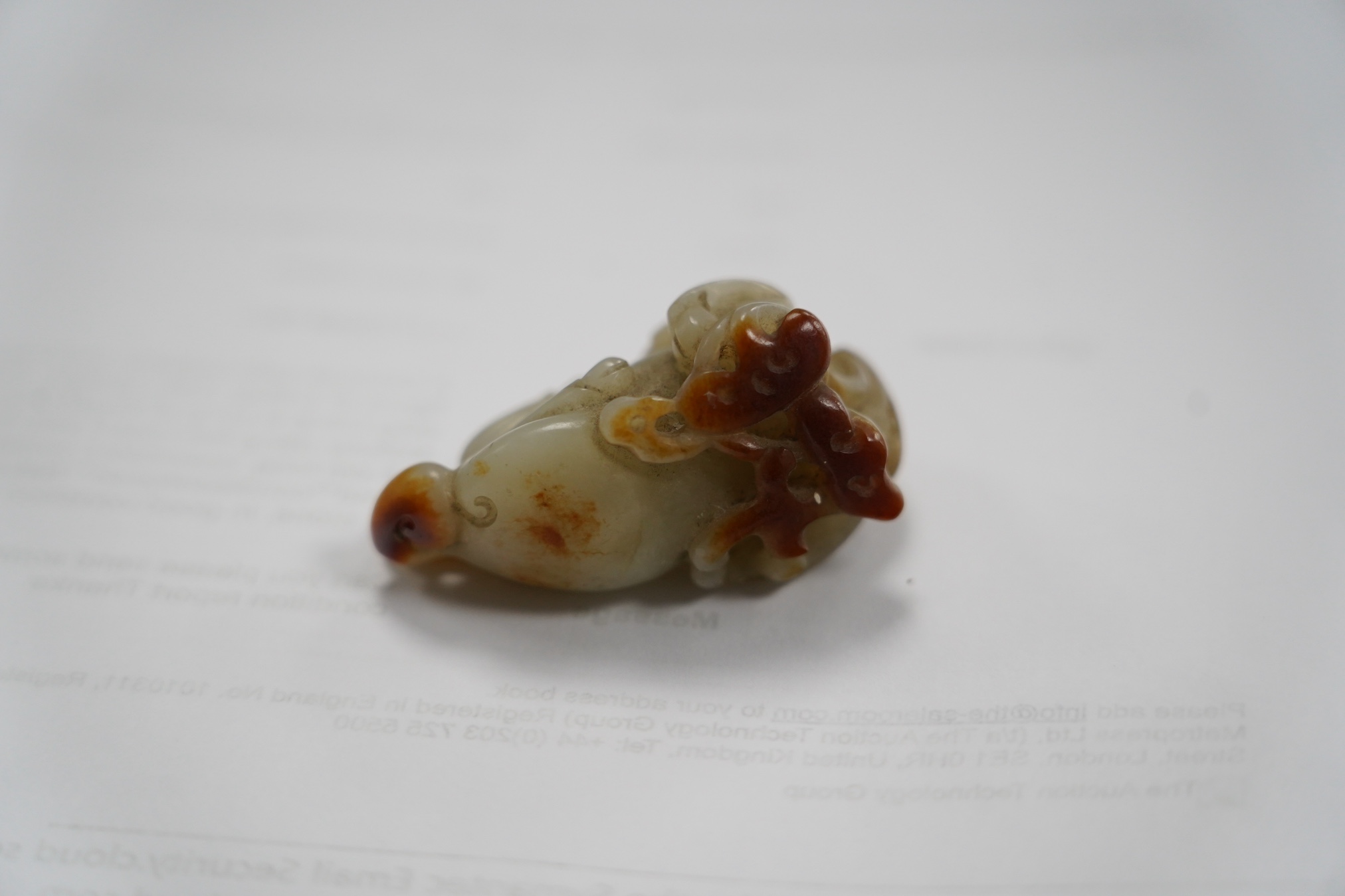A Chinese pale celadon and russet skin jade figure of a stag, 19th century